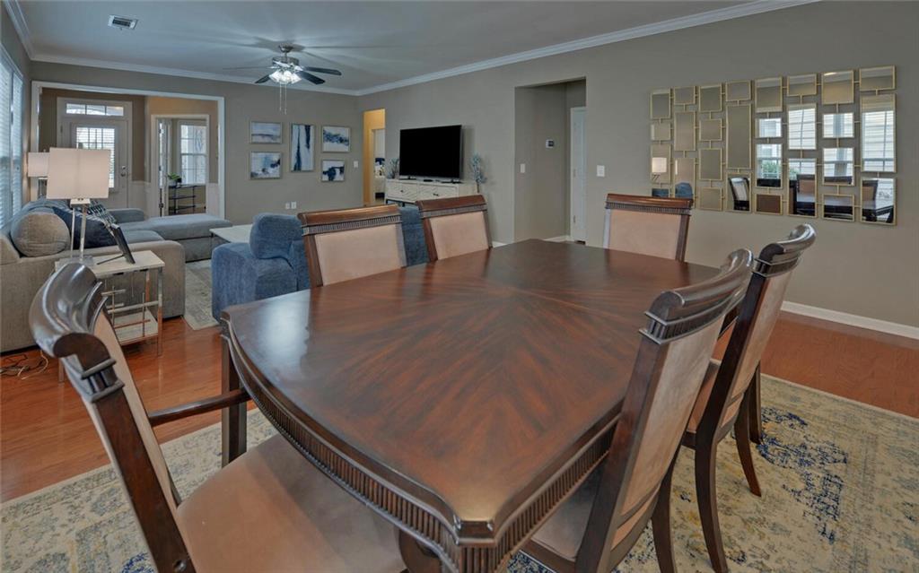 6213 Azalea Way Hoschton, GA 30548 - Photo 10 of 56 a living room with furniture a flat screen tv and a large window
