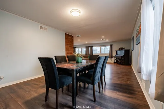 a kitchen with stainless steel appliances sink cabinets and wooden floor