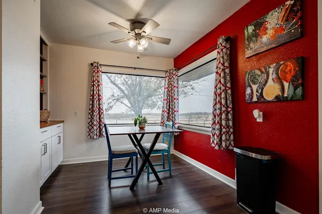 a kitchen with stainless steel appliances a stove a refrigerator and white cabinets
