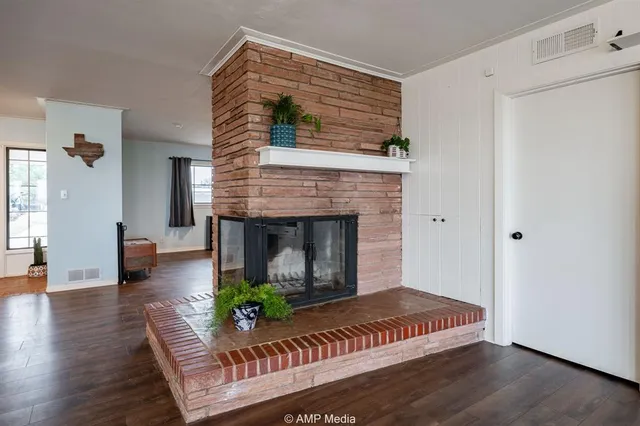 a view of a hallway with workspace and wooden floor
