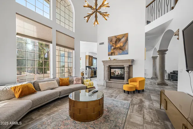 a living room with furniture a window and a flat screen tv