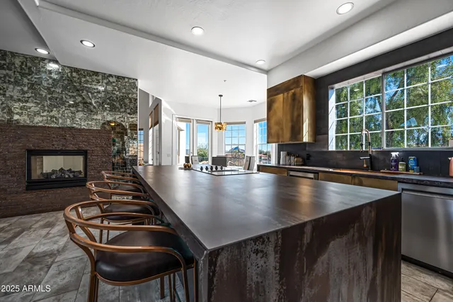 a kitchen with stainless steel appliances granite countertop a stove a sink and a refrigerator