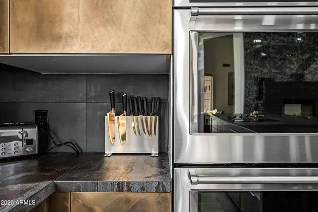 a kitchen with cabinets appliances and a sink