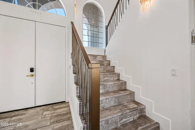 a view of a hallway with workspace and a window