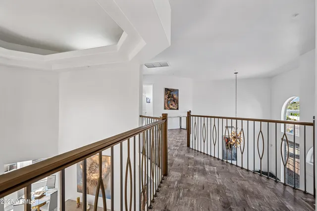a view of a hallway with wooden floor and entryway