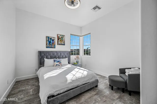 a view of a hallway with wooden floor and a bookshelf