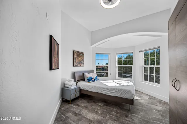 a bedroom with a bed and a window