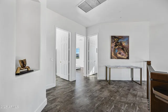 a bedroom with a bed and a painting on the wall