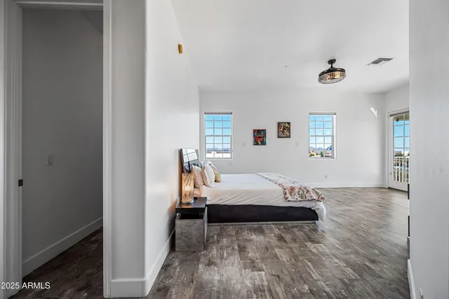 a view of a balcony with furniture and floor to ceiling windows
