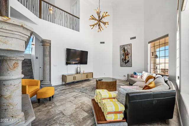 a kitchen with stainless steel appliances kitchen island granite countertop a refrigerator a stove a sink a dining table and chairs with wooden floor