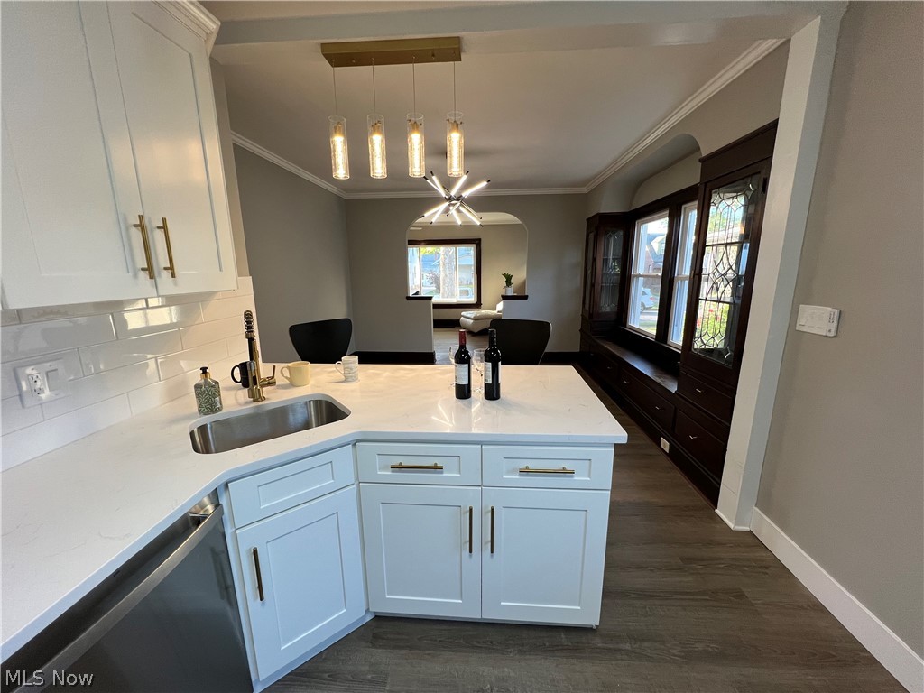 4523 Maplecrest Avenue Parma, OH 44134 - Photo 12 of 31 Kitchen with white cabinets, dark hardwood / wood-style floors, pendant lighting, sink, and dishwasher