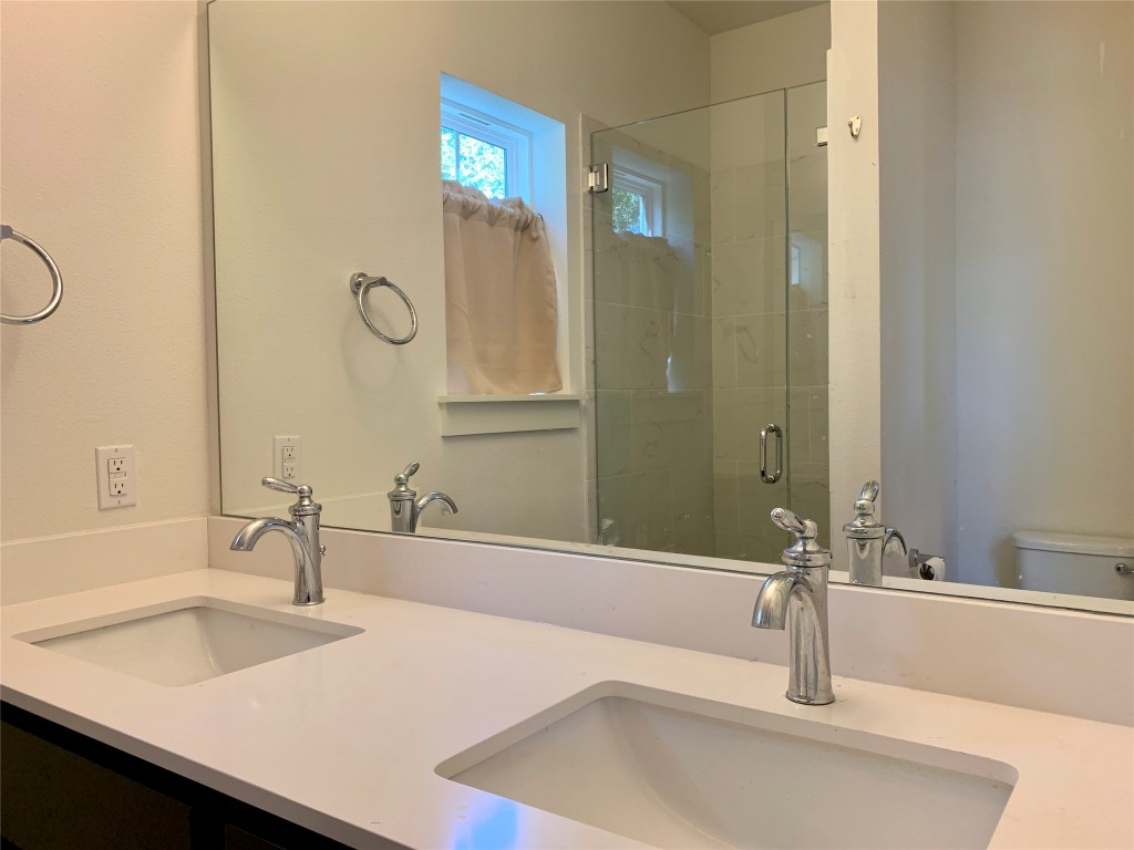5205 Samuel Huston Avenue, Unit B Austin, TX 78721 - Photo 16 of 37 a bathroom with a sink and a large mirror