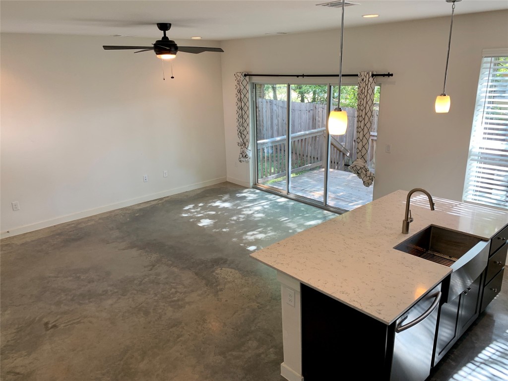 5205 Samuel Huston Avenue, Unit B Austin, TX 78721 - Photo 33 of 37 a kitchen with a sink a counter space and a chandelier