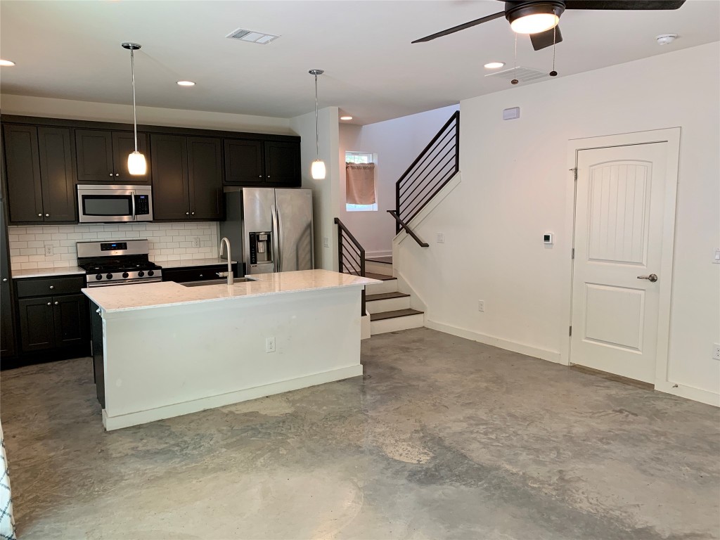 5205 Samuel Huston Avenue, Unit B Austin, TX 78721 - Photo 4 of 37 a view of kitchen with kitchen island stainless steel appliances a sink a stove and a couch