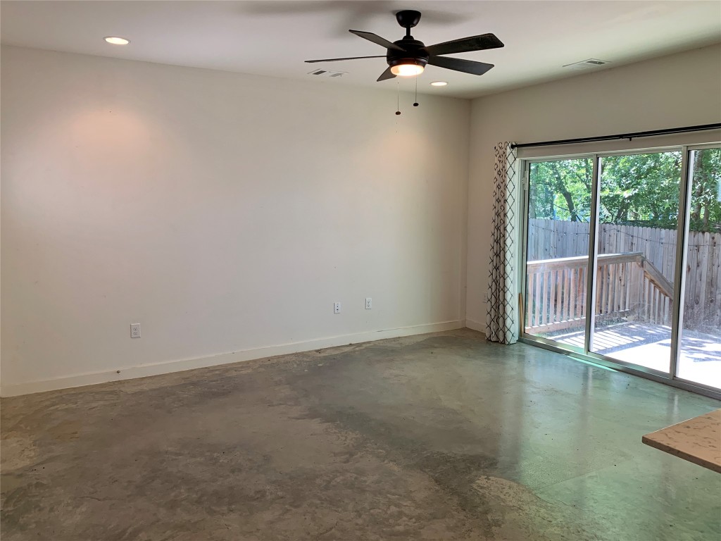 5205 Samuel Huston Avenue, Unit B Austin, TX 78721 - Photo 5 of 37 an empty room with sliding glass door