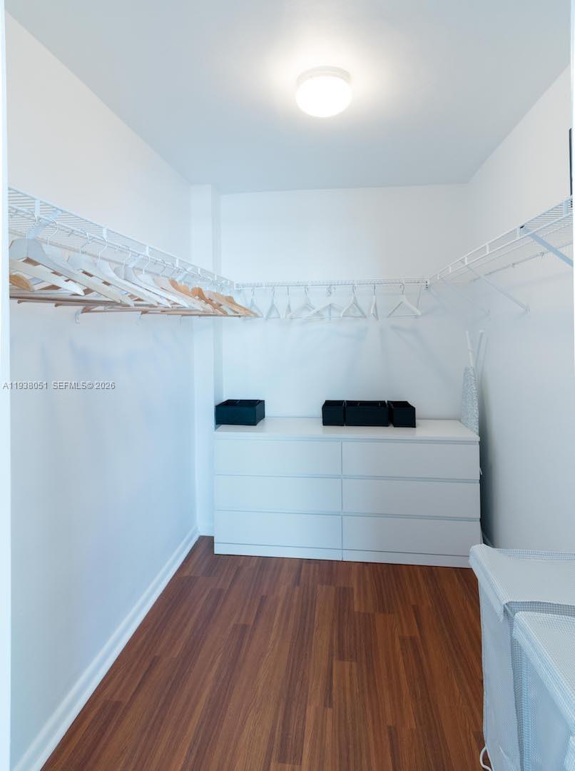 9195 Collins Avenue, Unit 611 Surfside, FL 33154 - Photo 13 of 33 a view of walk in closet with empty racks