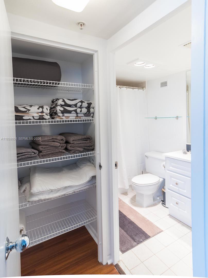 9195 Collins Avenue, Unit 611 Surfside, FL 33154 - Photo 15 of 33 a bathroom with a toilet and a shower