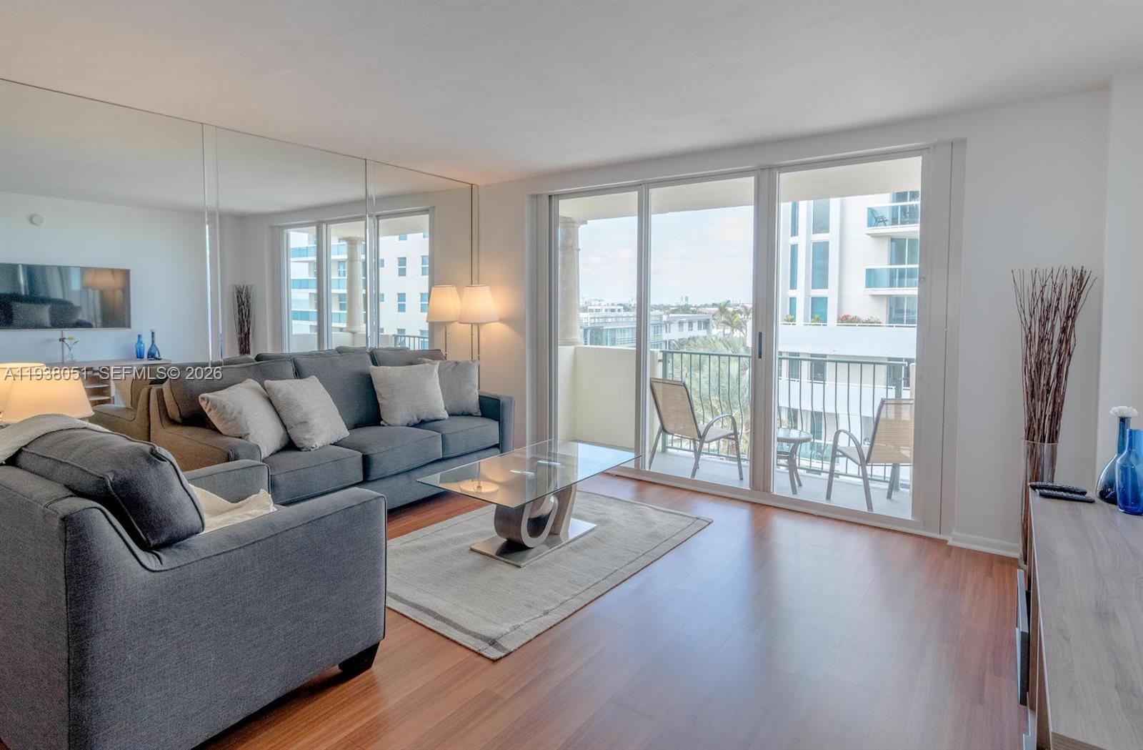 9195 Collins Avenue, Unit 611 Surfside, FL 33154 - Photo 2 of 33 a living room with furniture and a large window