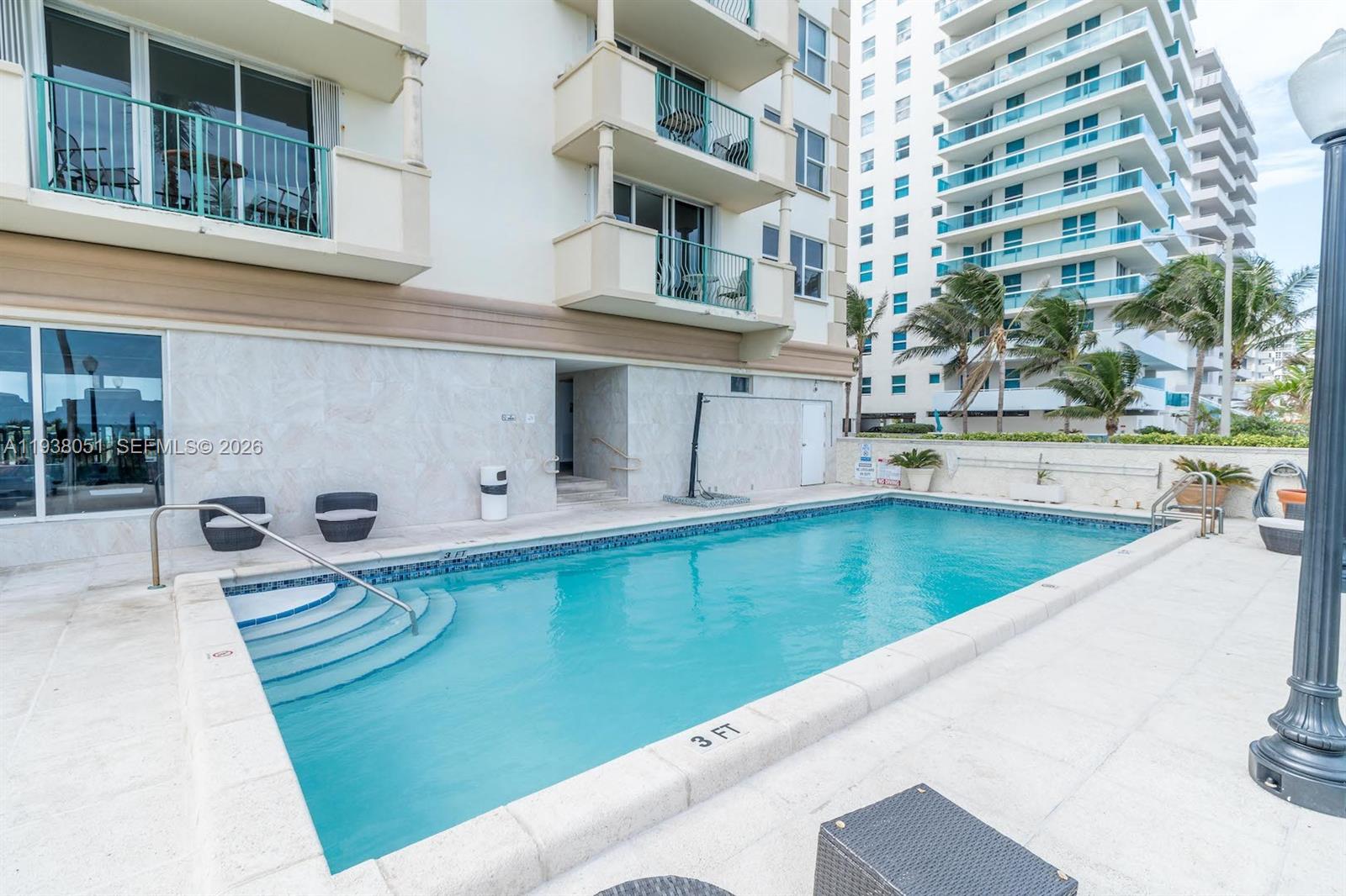 9195 Collins Avenue, Unit 611 Surfside, FL 33154 - Photo 22 of 33 a view of a swimming pool with a porch
