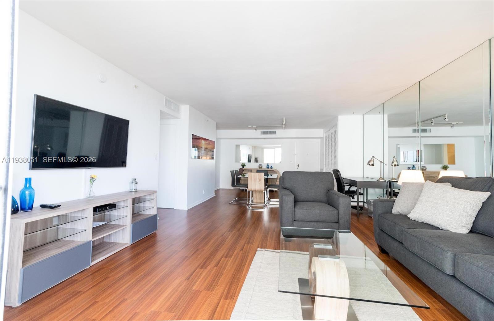 9195 Collins Avenue, Unit 611 Surfside, FL 33154 - Photo 6 of 33 a living room with furniture and a flat screen tv