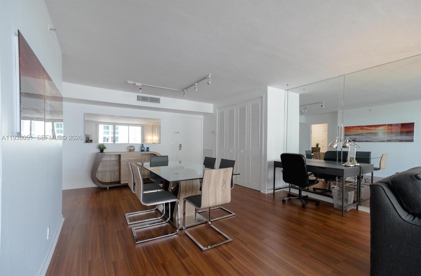 9195 Collins Avenue, Unit 611 Surfside, FL 33154 - Photo 7 of 33 a view of a dining room with furniture wooden floor and next to a window