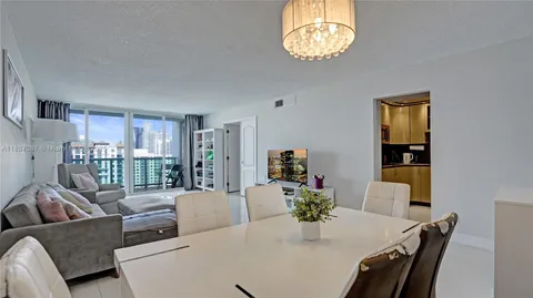 a view of a dining room with furniture and chandelier