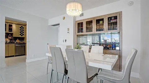 a dining room with furniture and chandelier