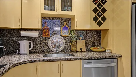 a kitchen with sink and cabinets