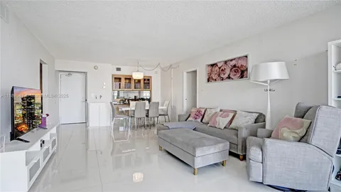 a living room with furniture a flat screen tv and a couch