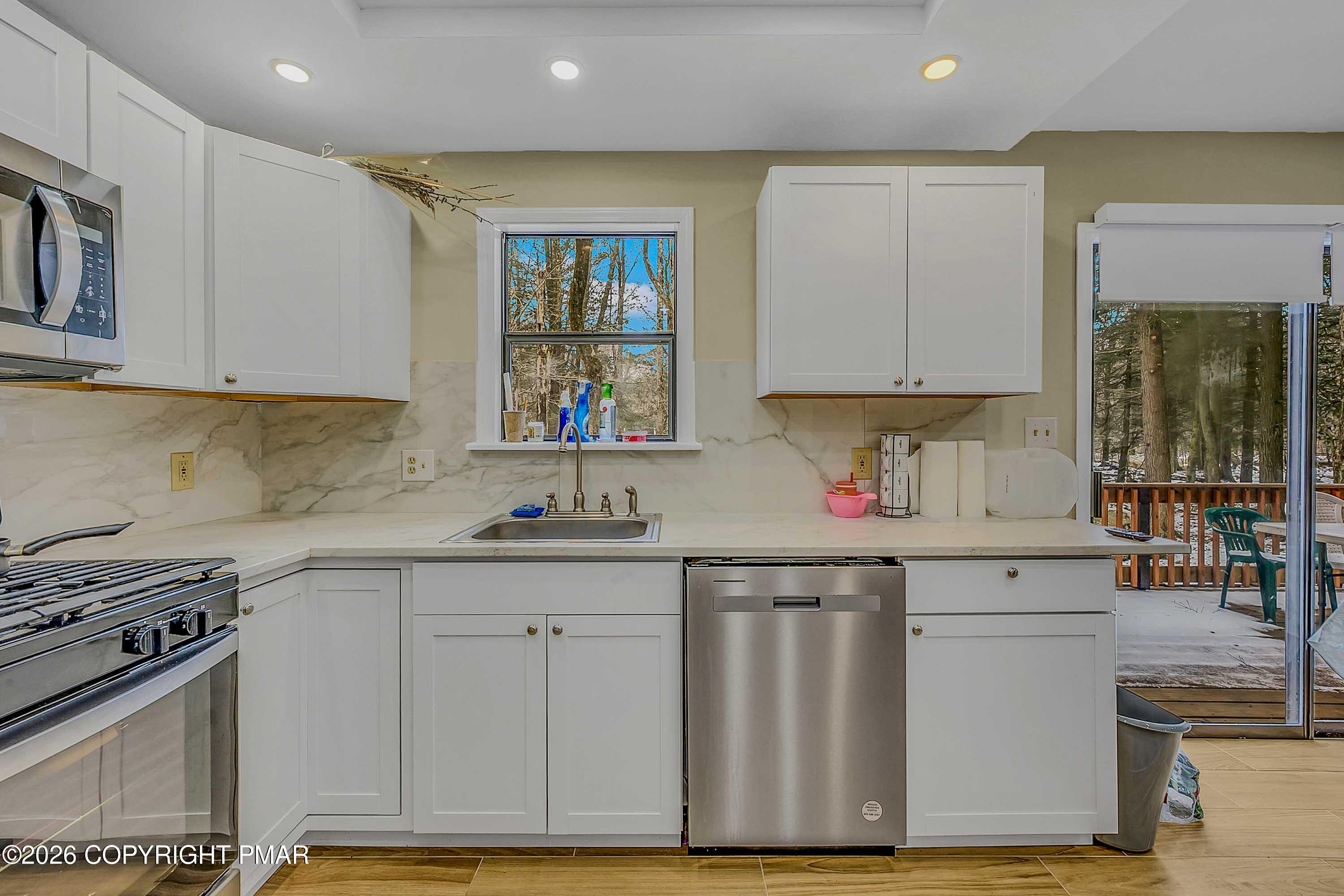 1027 Valley Road Newfoundland, PA 18445 - Photo 11 of 31 a kitchen with granite countertop a sink stainless steel appliances and cabinets