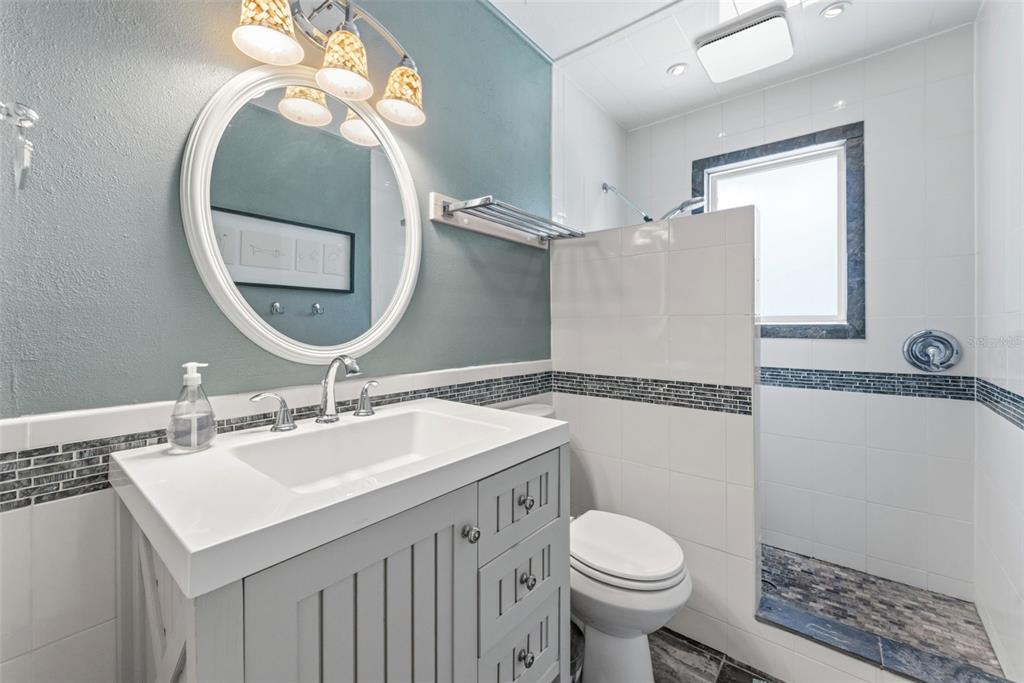 6355 Sebring Street Weeki Wachee, FL 34607 - Photo 38 of 65 a bathroom with a sink toilet and a mirror