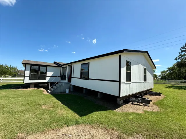 a front view of a house with a yard fire pit tables and chairs