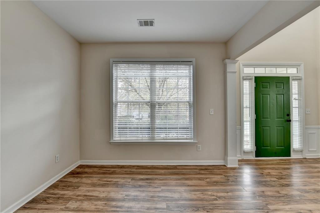 100 Hawnley Trc Northwest Suwanee, GA 30024 - Photo 30 of 58 a view of an empty room with wooden floor and a window