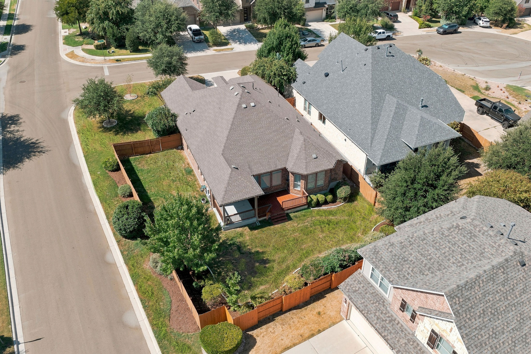 6100 Gunnison Turn Road Austin, TX 78738 - Photo 9 of 34 An aerial view showcases the fully fenced grassy backyard and covered rear porch.