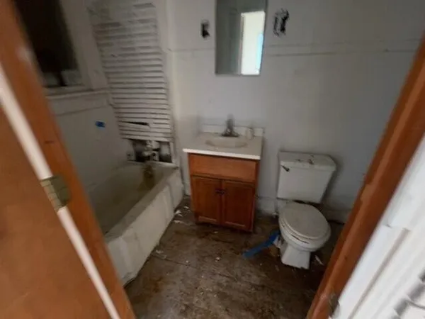 a bathroom with a toilet a sink and a bathtub