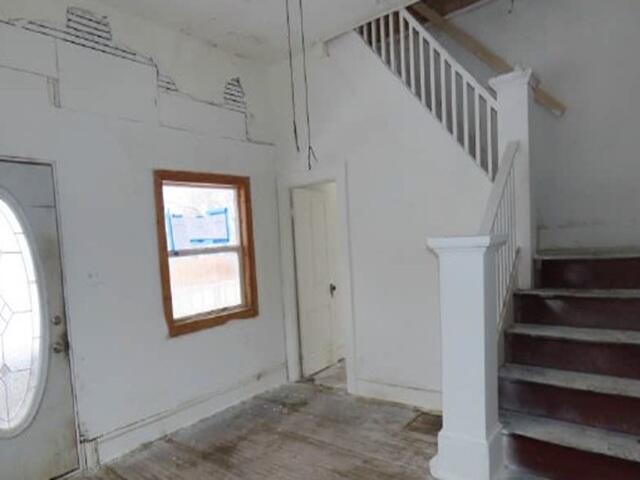 62 South Wayne Street Peru, IN 46970 - Photo 4 of 11 a view of hallway with stairs and wooden floor