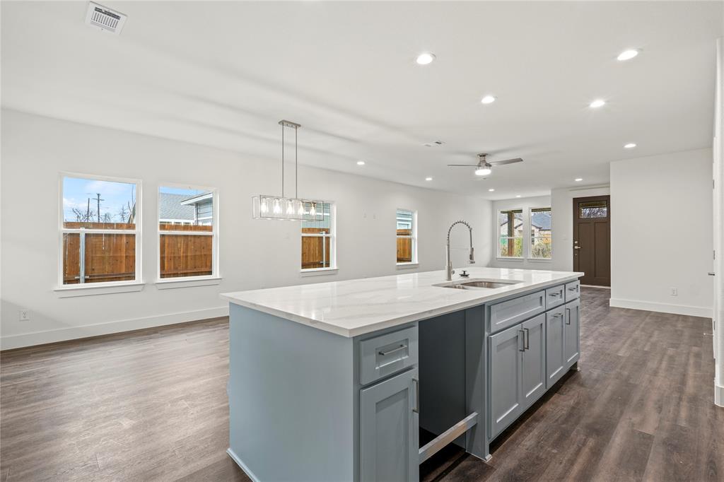 3335 Spring Avenue Dallas, TX 75215 - Photo 12 of 22 a kitchen with a sink stove and wooden cabinets