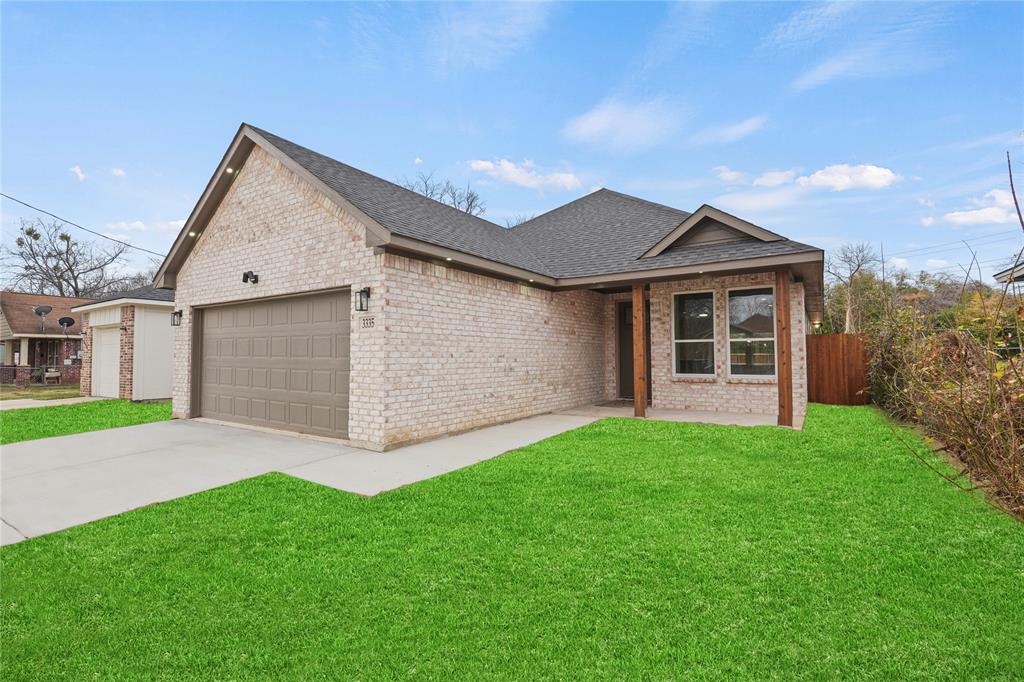 3335 Spring Avenue Dallas, TX 75215 - Photo 4 of 22 a view of a house with a yard and garage