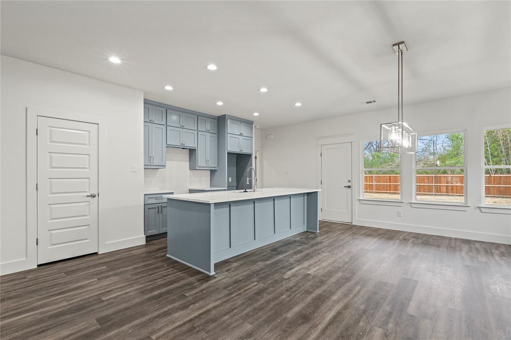 3335 Spring Avenue Dallas, TX 75215 - Photo 7 of 22 a kitchen with stainless steel appliances granite countertop a sink a counter space and wooden floor