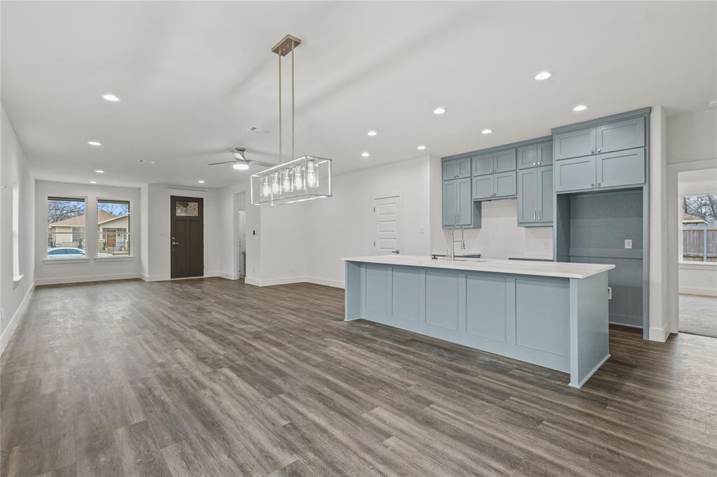 3335 Spring Avenue Dallas, TX 75215 - Photo 10 of 22 a large kitchen with kitchen island a sink stainless steel appliances and cabinets