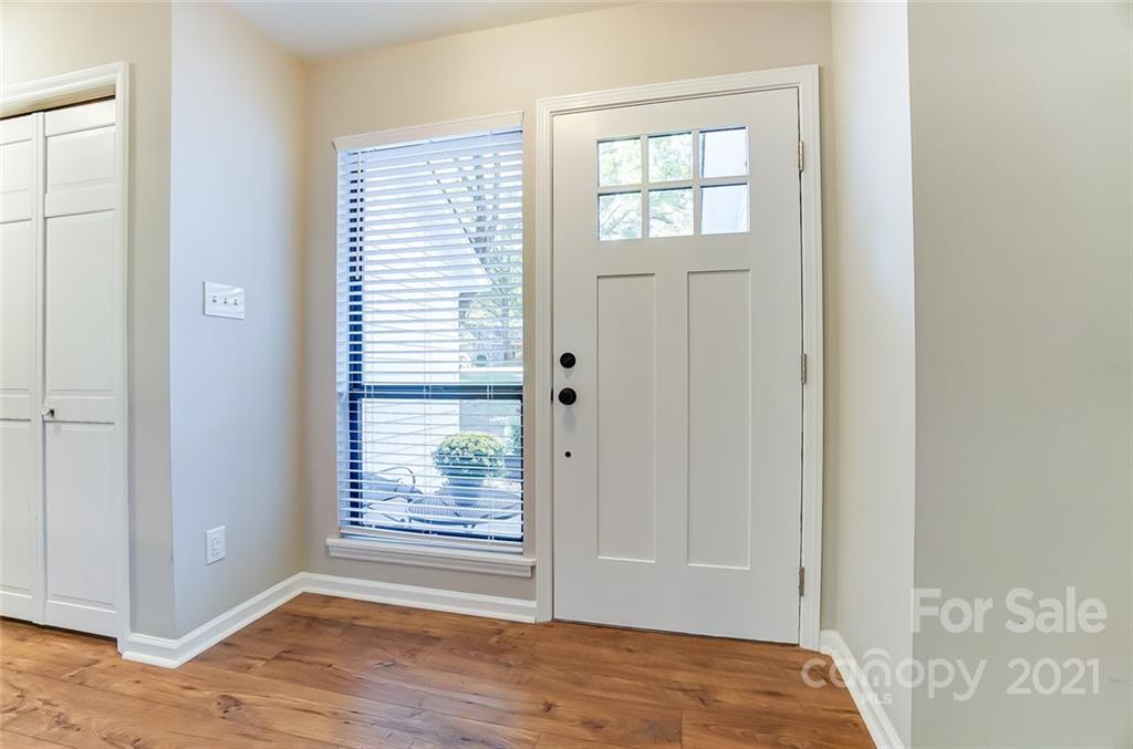 31016 Executive Point, Unit 15 Tega Cay, SC 29708 - Photo 2 of 35 a view of an empty room with wooden floor and a window