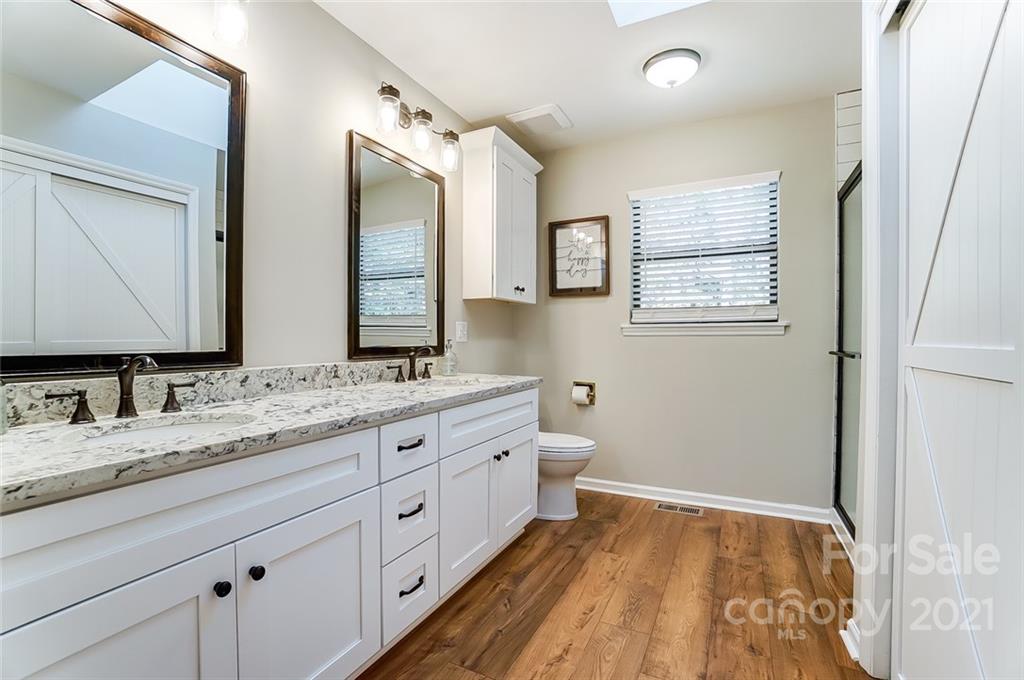 31016 Executive Point, Unit 15 Tega Cay, SC 29708 - Photo 15 of 35 a bathroom with a granite countertop sink mirror and a