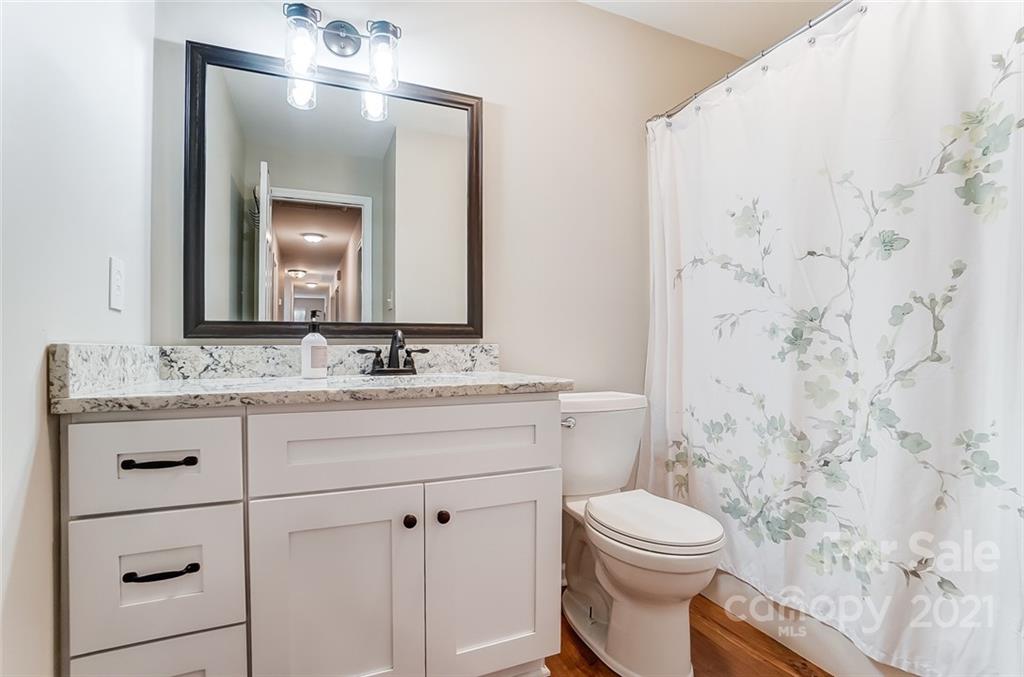 31016 Executive Point, Unit 15 Tega Cay, SC 29708 - Photo 19 of 35 a bathroom with a sink a toilet and shower
