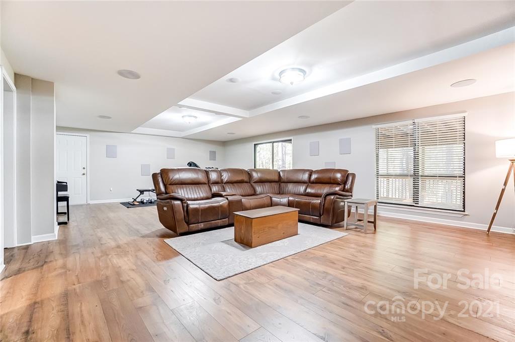 31016 Executive Point, Unit 15 Tega Cay, SC 29708 - Photo 22 of 35 a living room with furniture and wooden floor