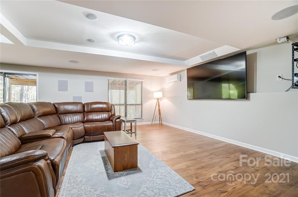 31016 Executive Point, Unit 15 Tega Cay, SC 29708 - Photo 23 of 35 a living room with furniture and a flat screen tv