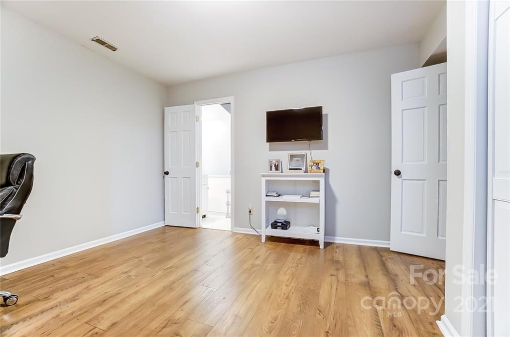 31016 Executive Point, Unit 15 Tega Cay, SC 29708 - Photo 25 of 35 a view of empty room with wooden floor and cabinet