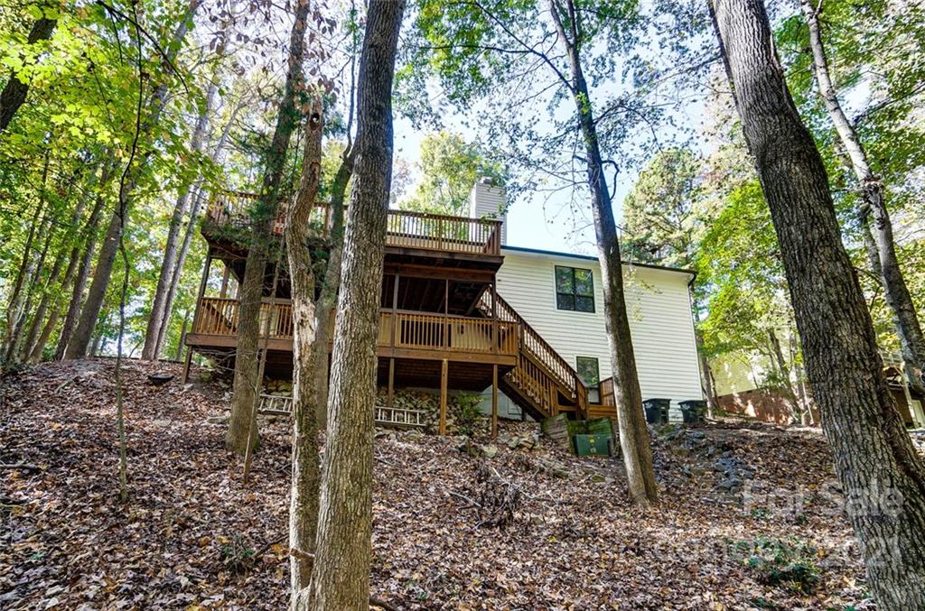 31016 Executive Point, Unit 15 Tega Cay, SC 29708 - Photo 29 of 35 a backyard of a house with wooden stairs and outdoor seating