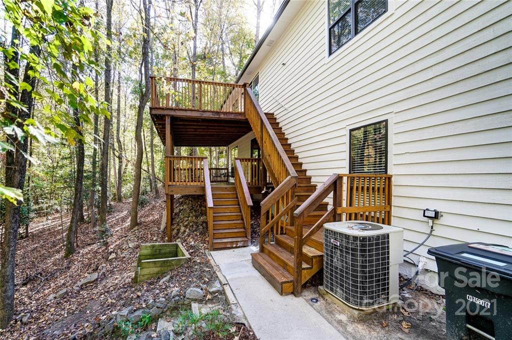 31016 Executive Point, Unit 15 Tega Cay, SC 29708 - Photo 30 of 35 a view of a house with backyard and wooden deck