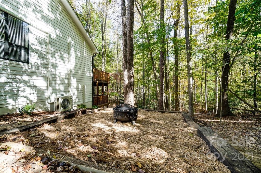 31016 Executive Point, Unit 15 Tega Cay, SC 29708 - Photo 32 of 35 a backyard of a house with outdoor seating