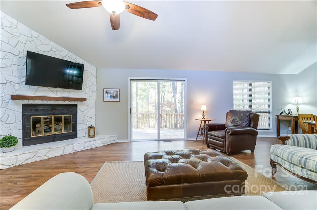 31016 Executive Point, Unit 15 Tega Cay, SC 29708 - Photo 5 of 35 a living room with furniture a flat screen tv and a fireplace